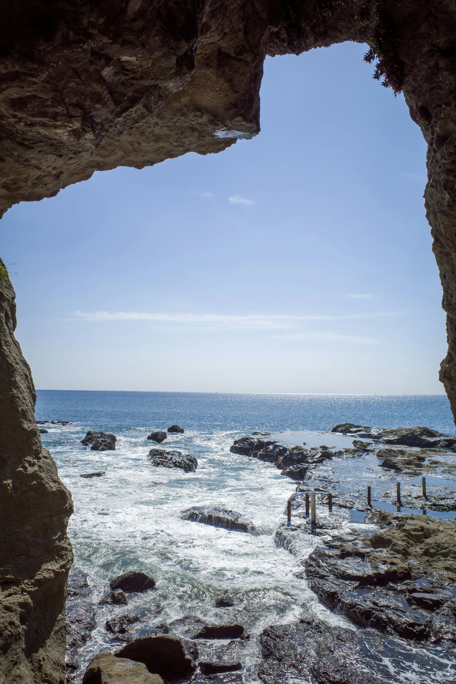 a view out a large, hole in the rock formation