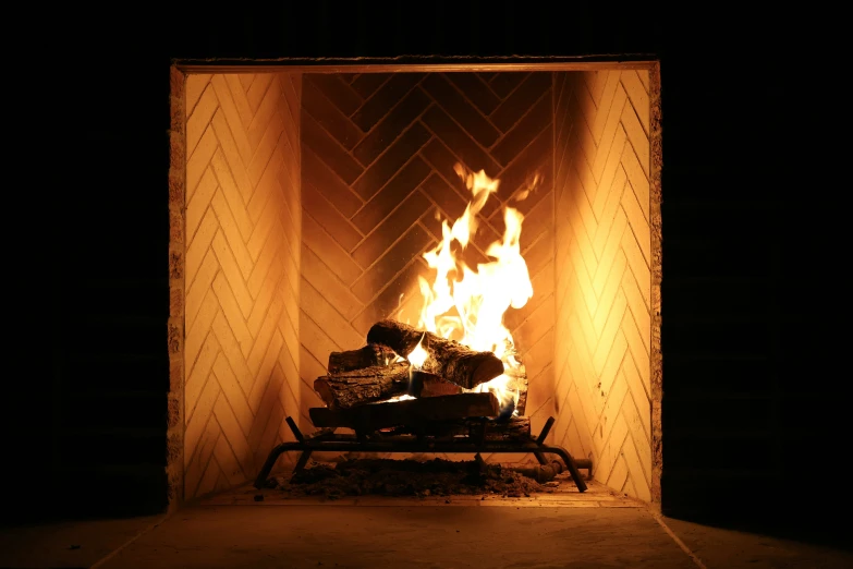 a wood burning in a fireplace with a black background