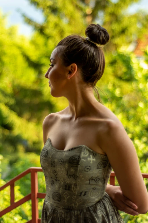 a beautiful woman in a dress standing outdoors