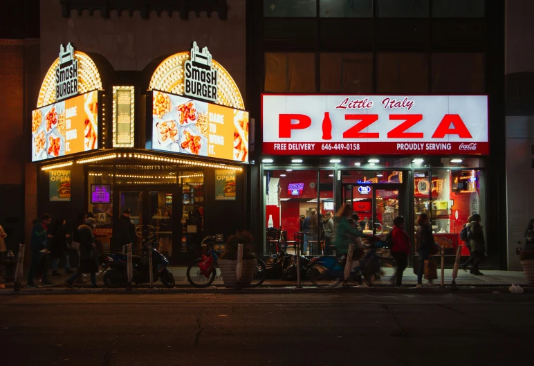 people waiting to go into a pizza shop