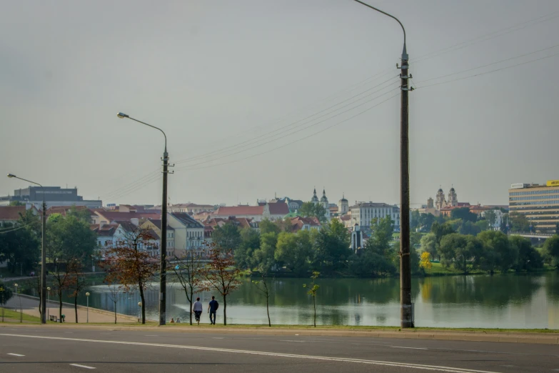 view of some buildings and a body of water with trees in the foreground