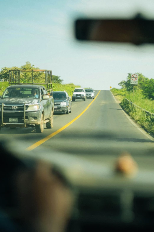 the view of a street and a vehicle from a vehicle windshield