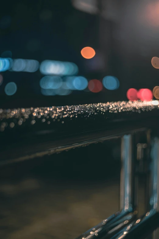 rain drops are on the rails at night time