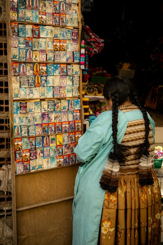 an old woman stands next to a box display