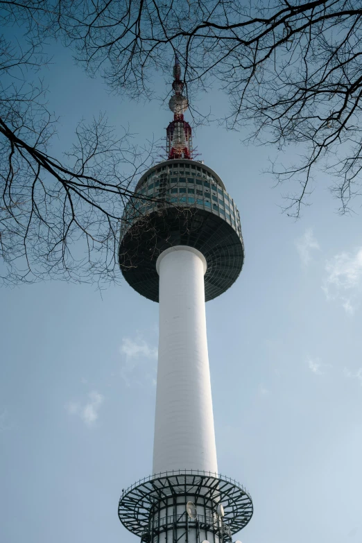 a white tower that has a red and white top