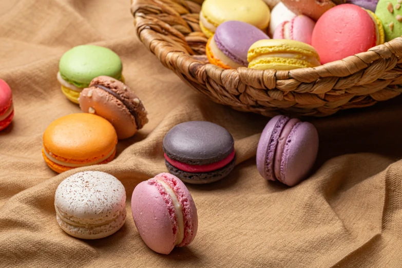 a basket of colorful macaroons is sitting on a table