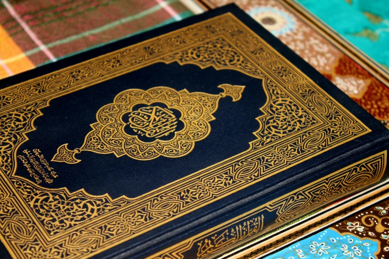 this book is black with gold trim and ornate patterns