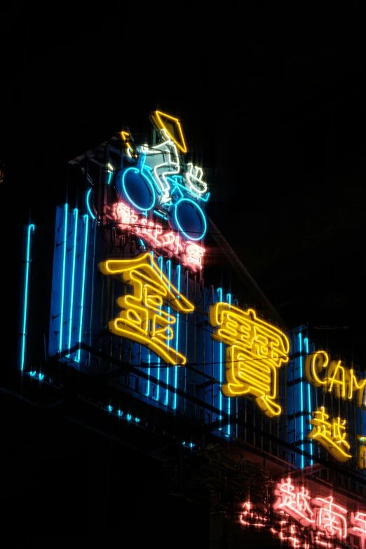 signs lit up outside in a large city