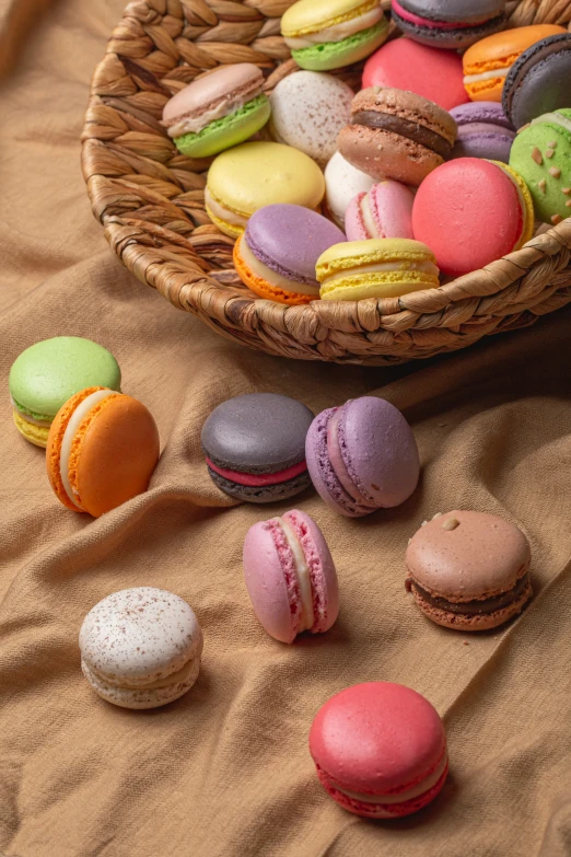 a basket filled with small macaroons and pastries