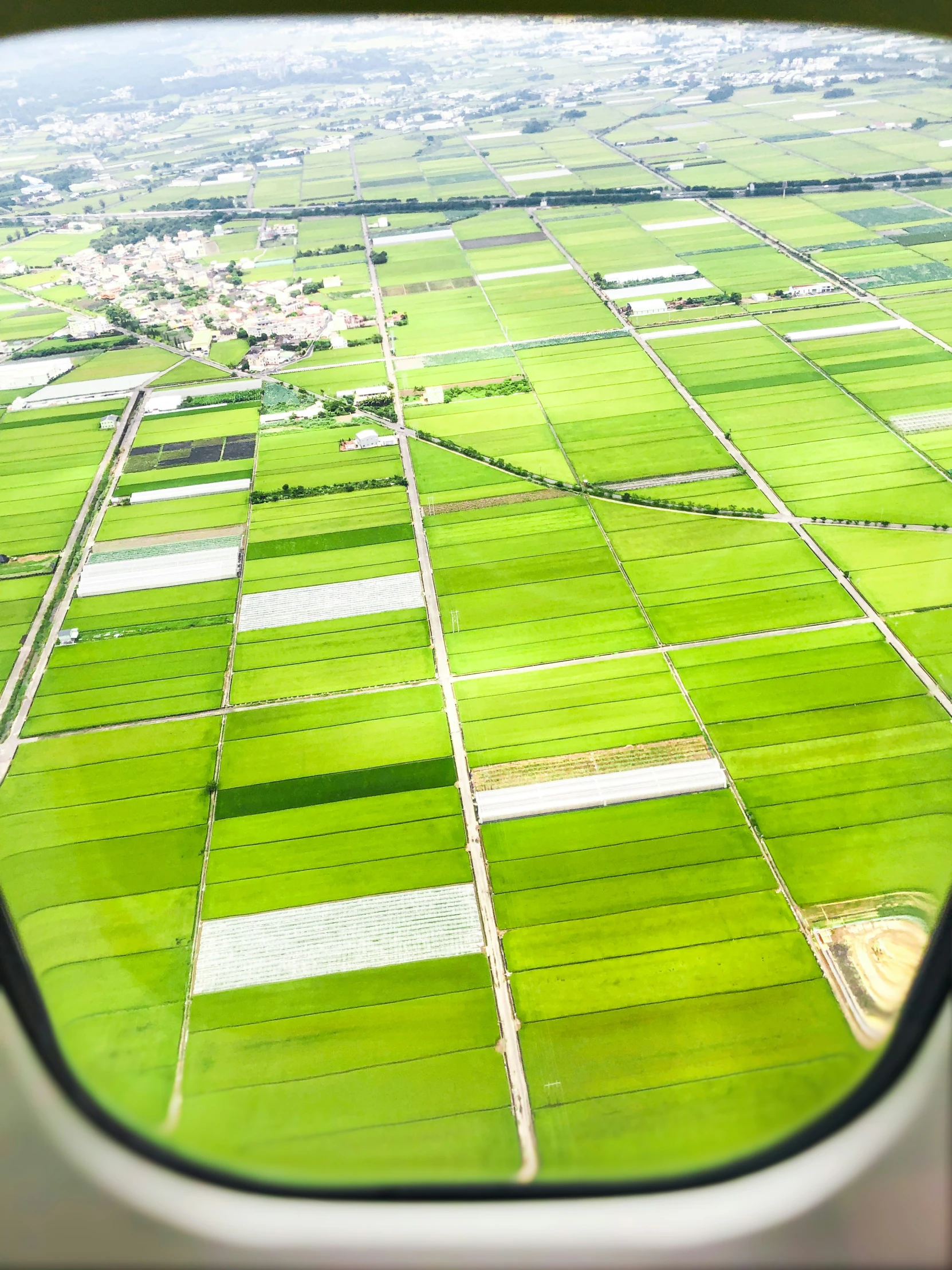 a view of the fields from an airplane window