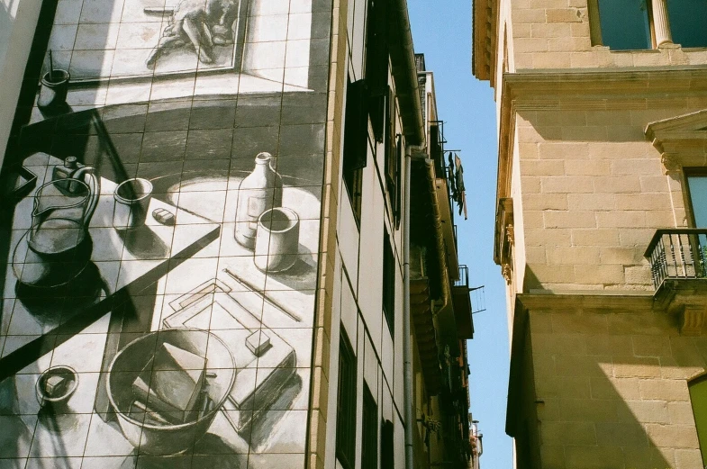 the mural on the side of a building with a kitchen scene