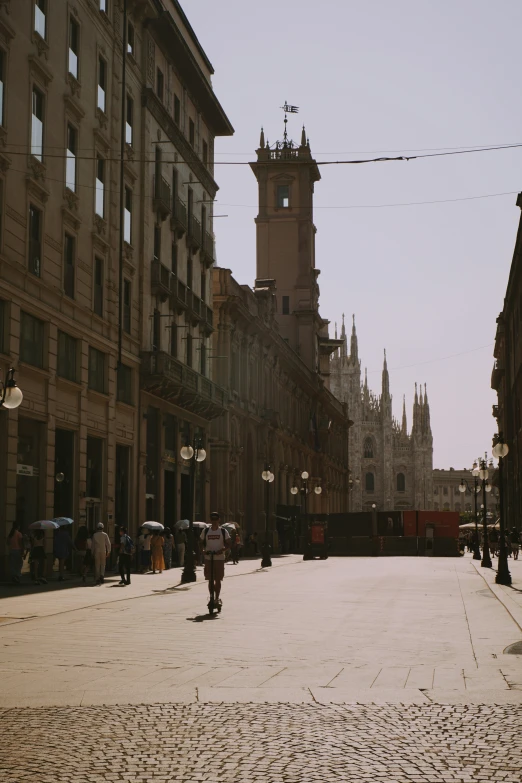 an old european city with lots of people walking around