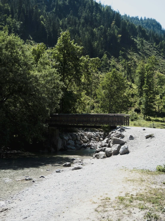 a bench and a walkway next to a river