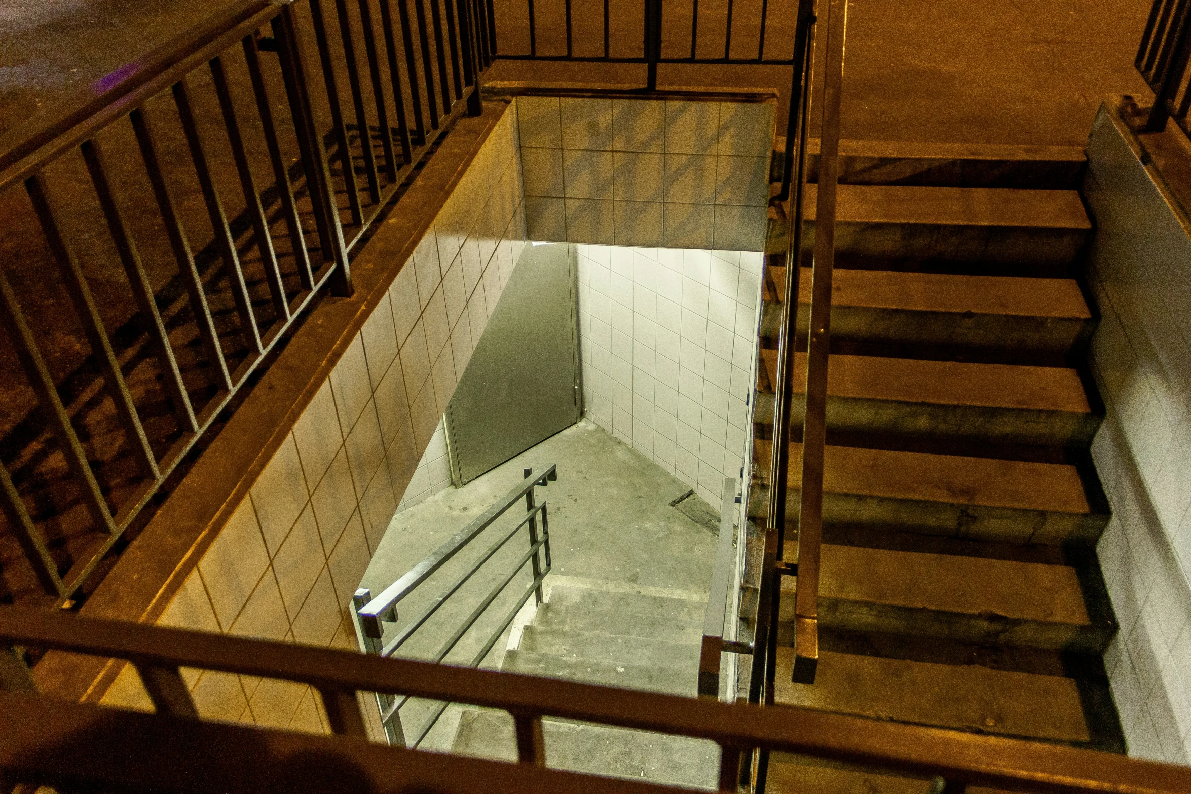 two people are sitting at the bottom of a stairway