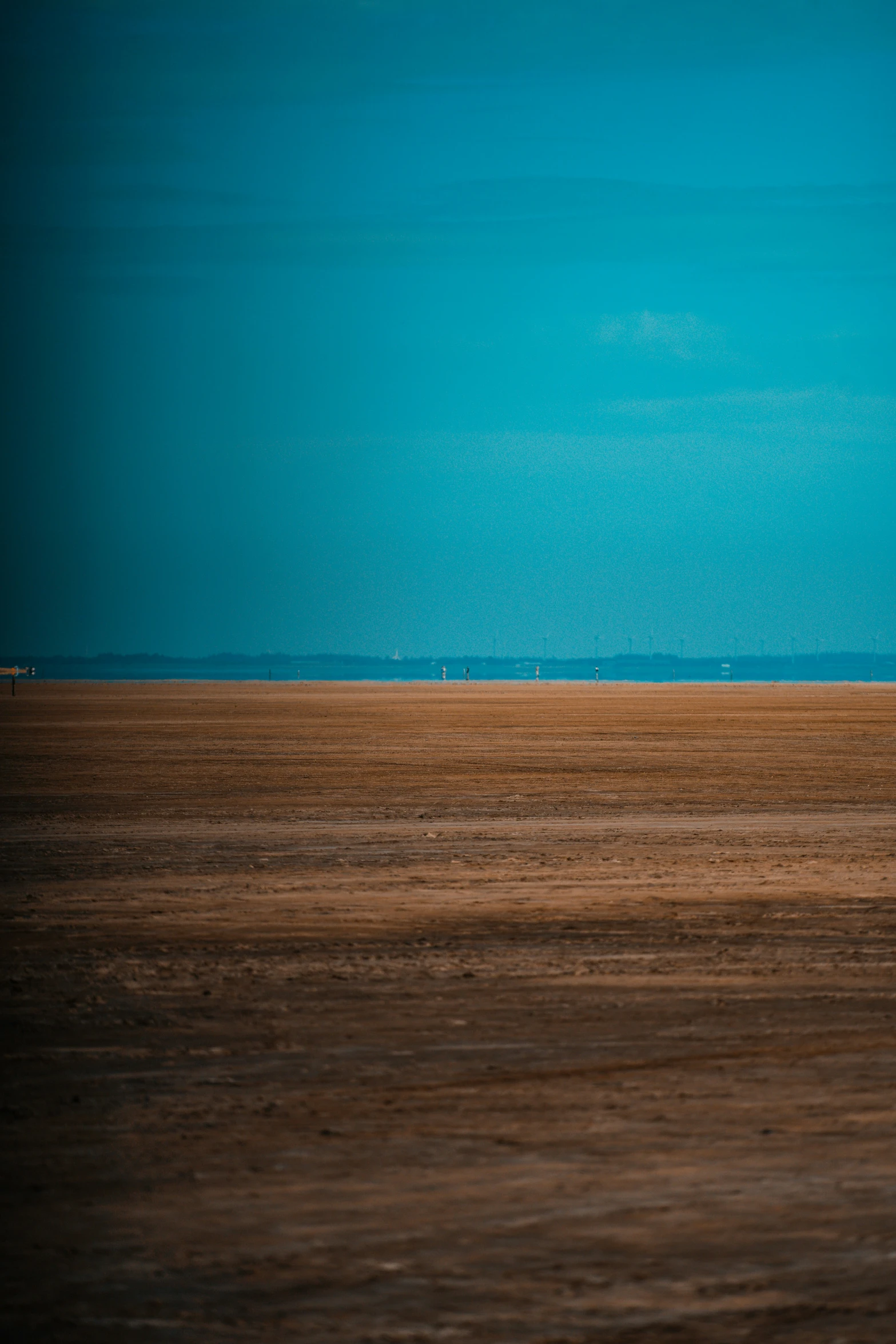 two people riding a horse in an empty field