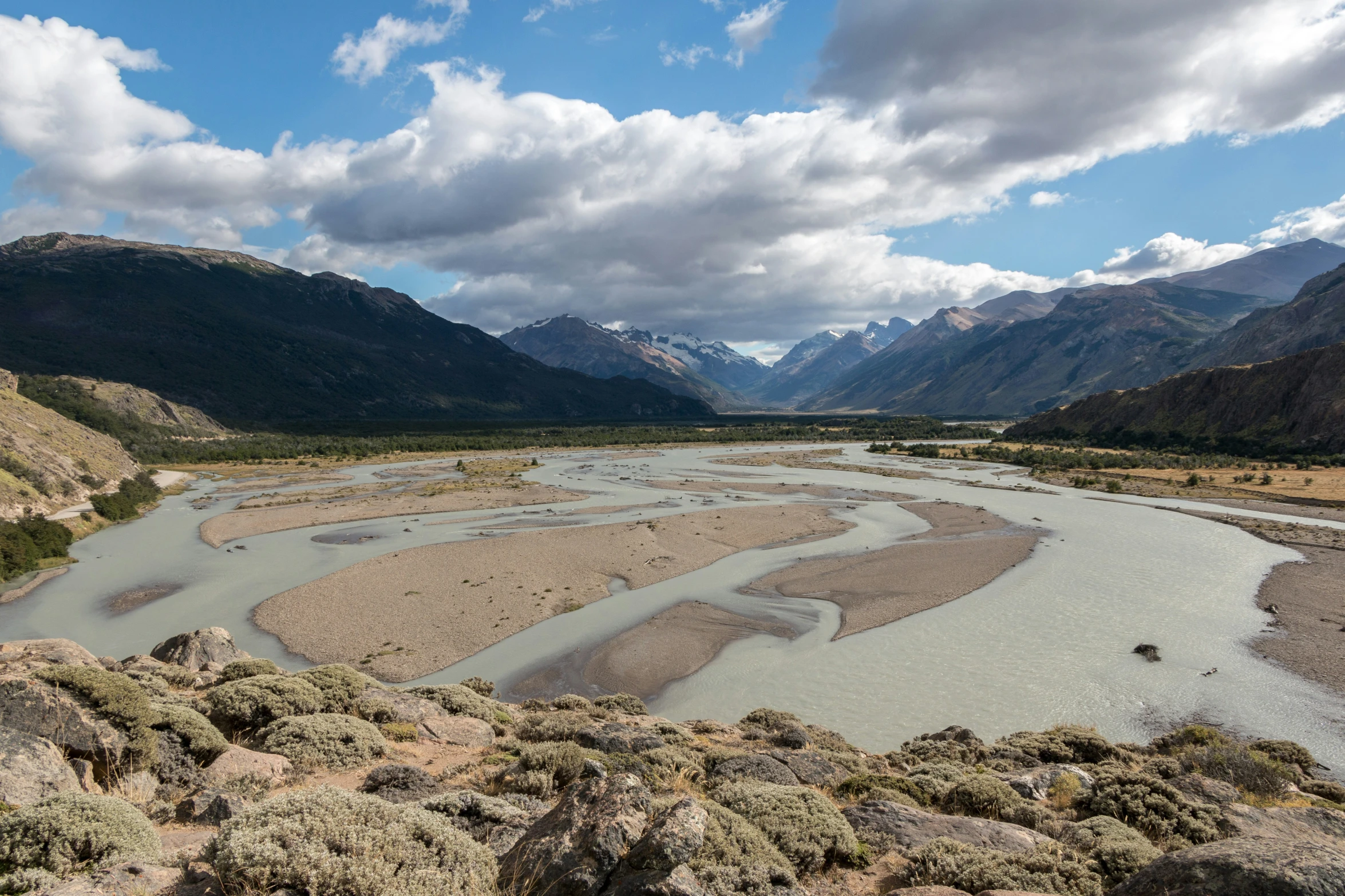 a river running through the middle of mountains