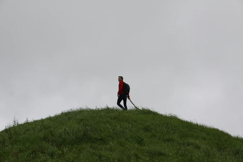 a man walks down the side of a hill