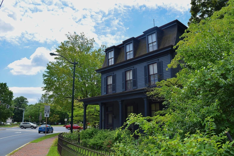 a small house that has cars parked in front