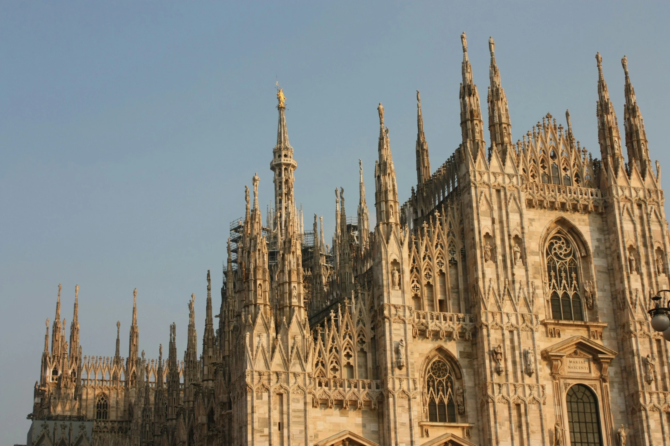 large cathedral like building with pointed spires against the blue sky