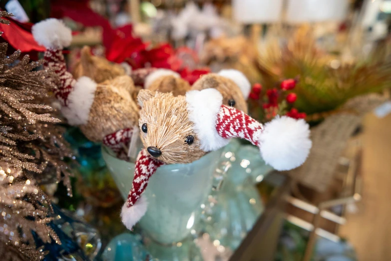 a teddy bear figurine with red and white hats on