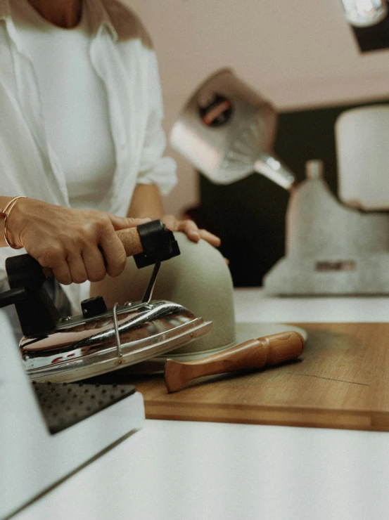 woman using a machine to cut the cheese