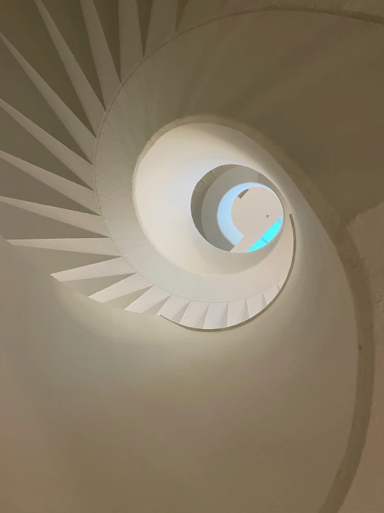 a view of an overhead white spiral in the ceiling