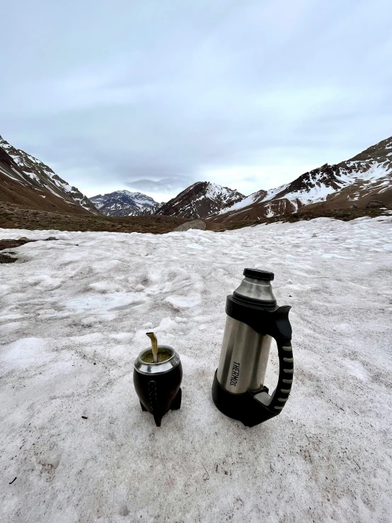 a cup and cup lid sitting on top of snow