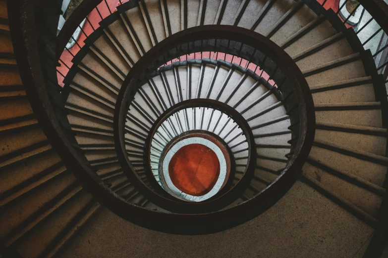 a very pretty looking spiral staircase with red carpet