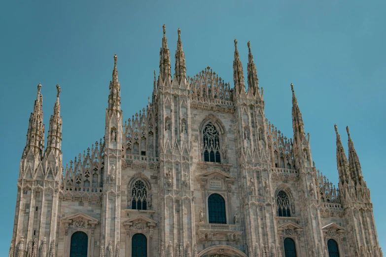 an old cathedral with spires under a clear blue sky