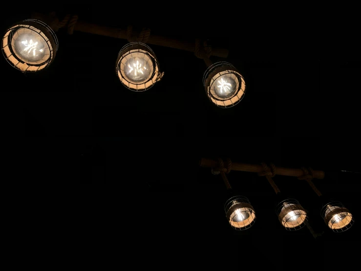 a row of light bulbs hanging from the side of a street pole