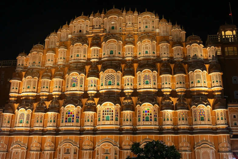 a very tall building lit up with lights and decorations