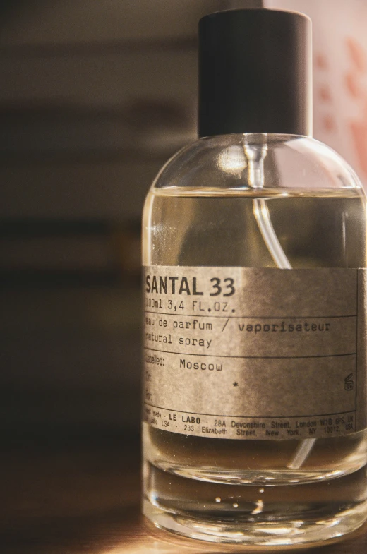 a glass bottle of sanitil 33 on a table