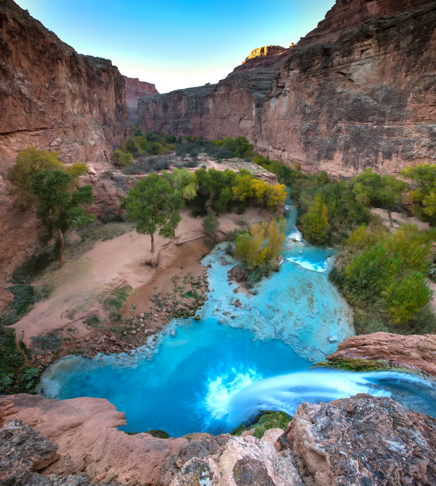 a small river running through the middle of mountains