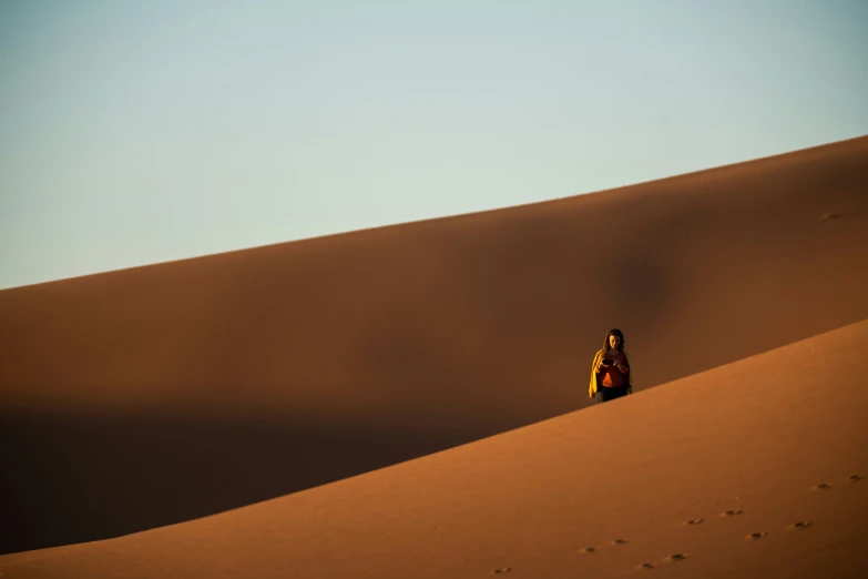 two people standing in the desert and watching soing