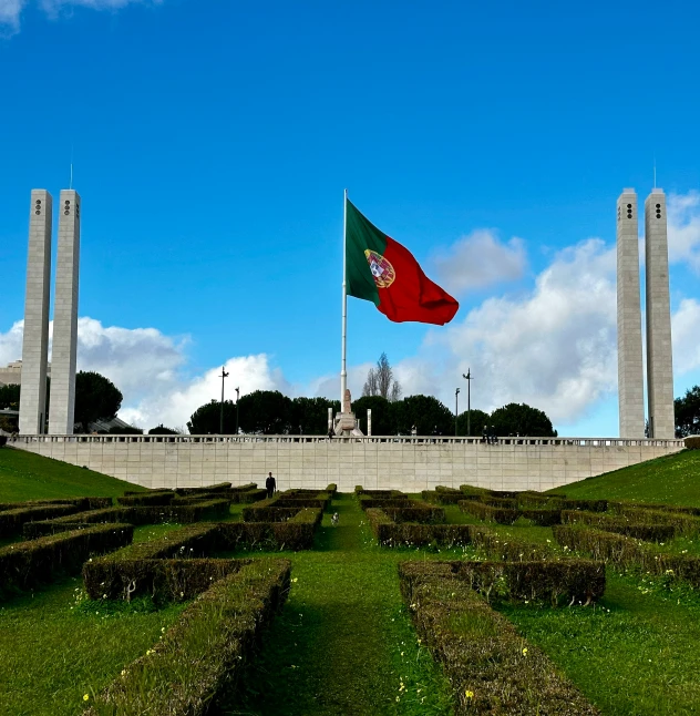 a large flag that is over looking a monument