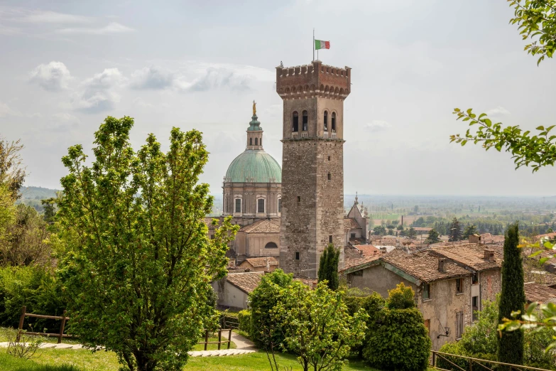 a church in a city that has a green dome on top of it