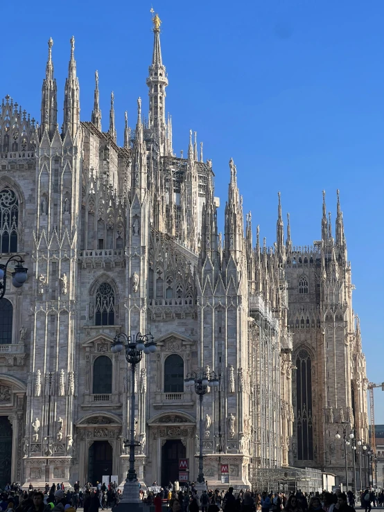 a large cathedral with towers is seen against a blue sky