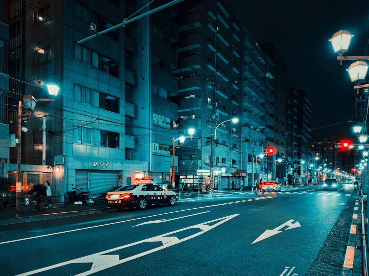 an empty city street at night with two red traffic lights