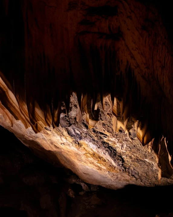 a cave wall with large, stalazite caves on the sides