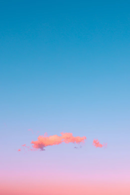 a jet flying through the sky at dusk