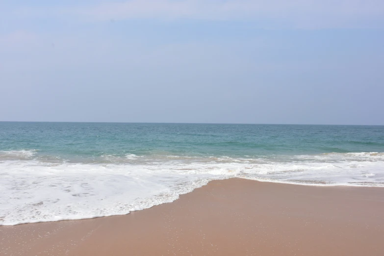 an ocean view with the sand blowing in front of it