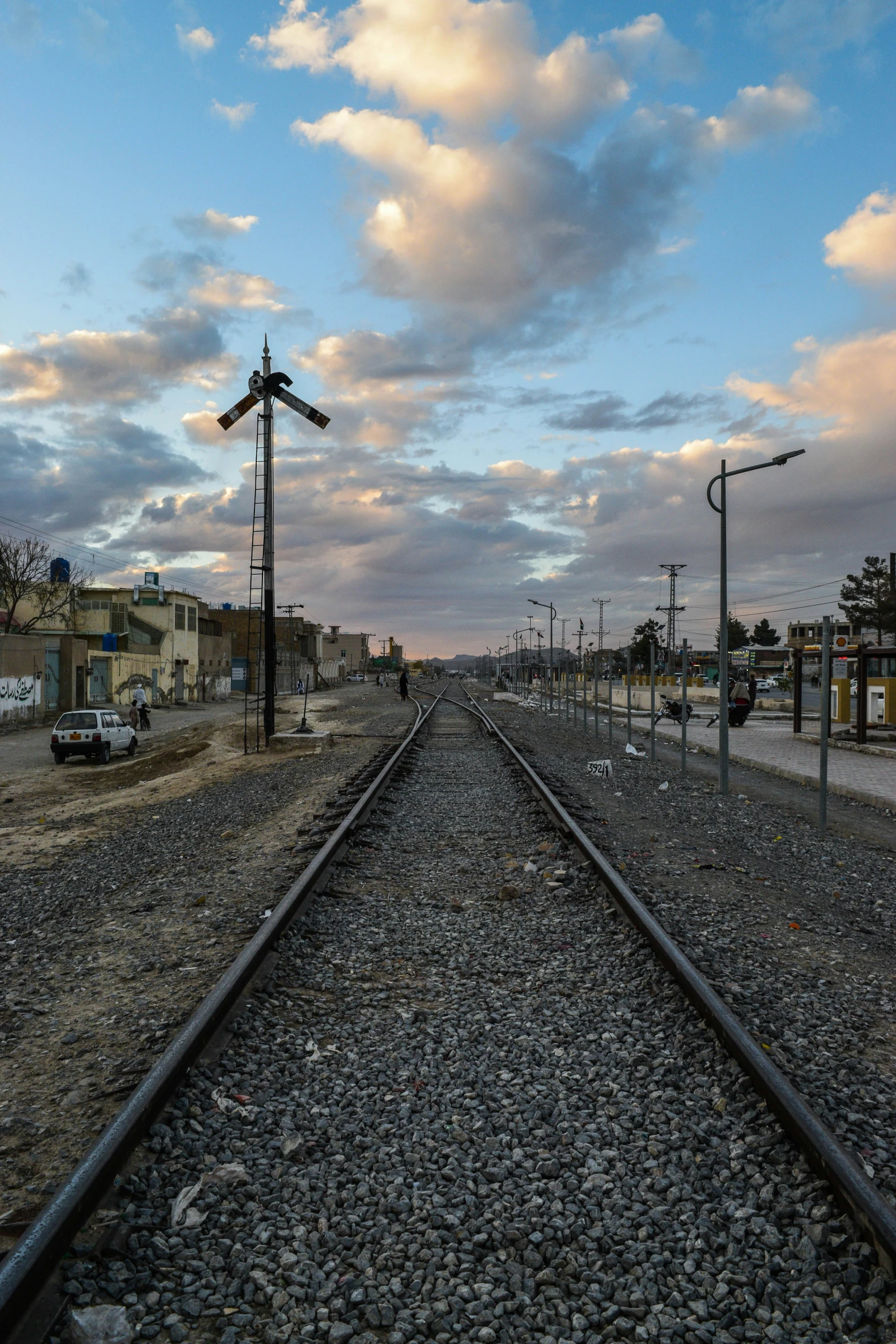 a long train track runs through an abandoned city