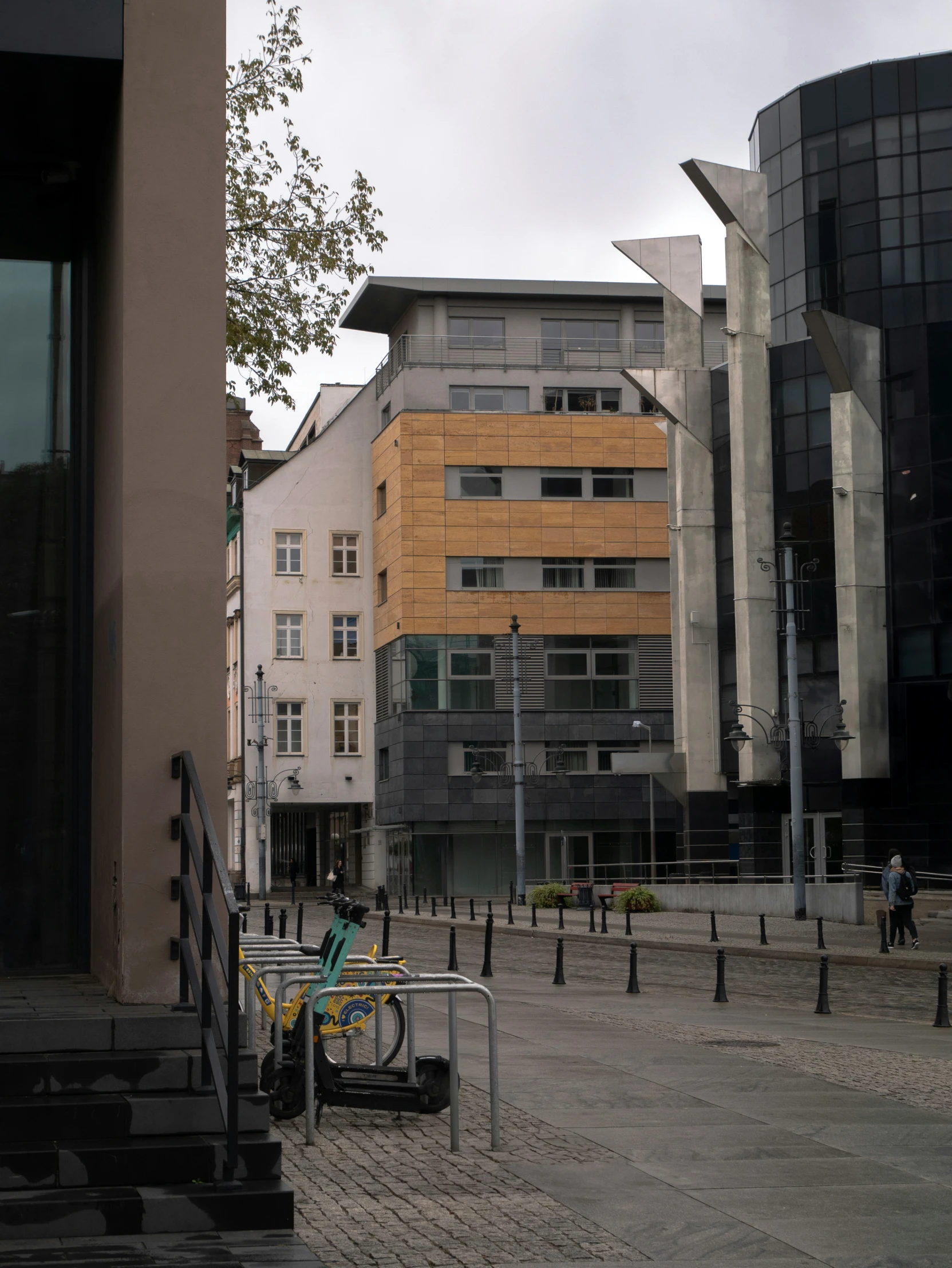 people in a courtyard with some buildings in the background