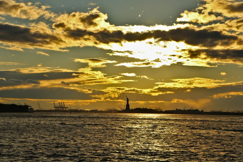 the sun rising over the horizon in a sea view