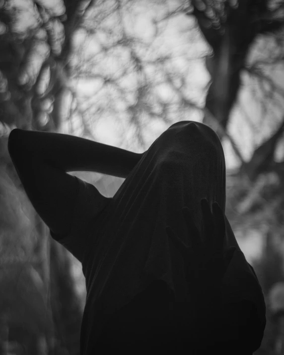 a woman wearing a black outfit in the woods