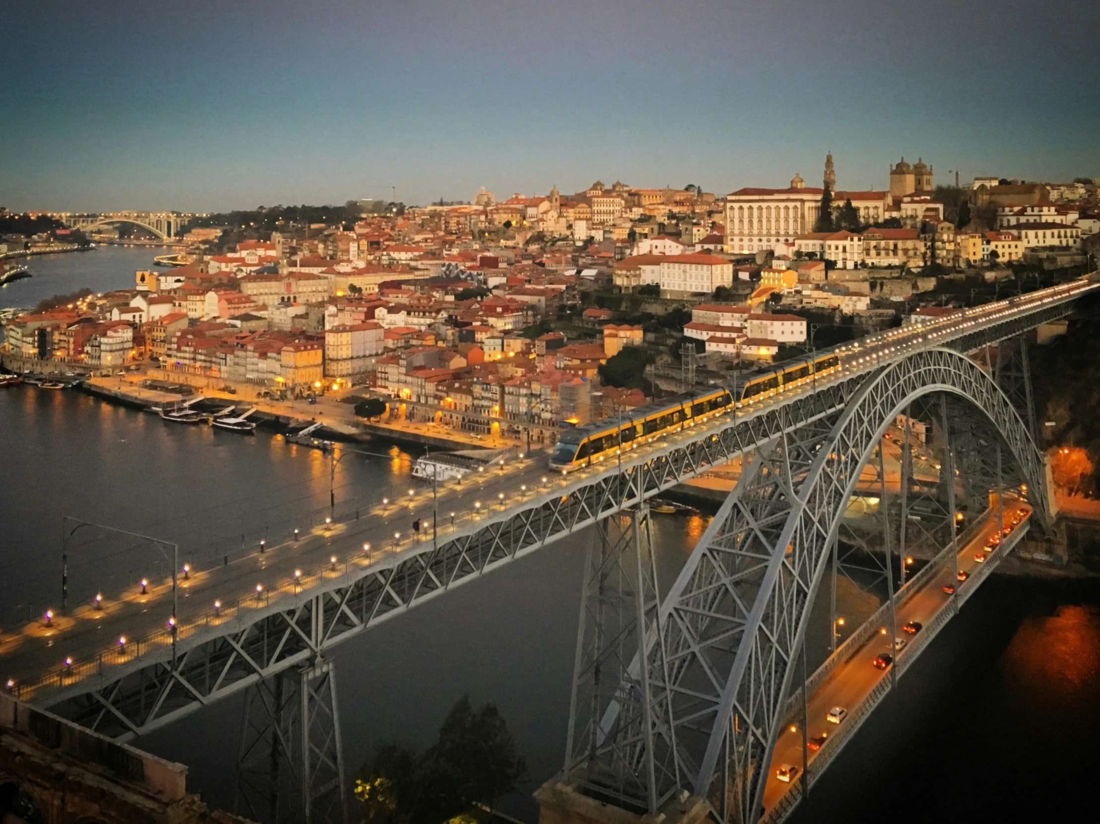 a bridge with light rail crossing over the city