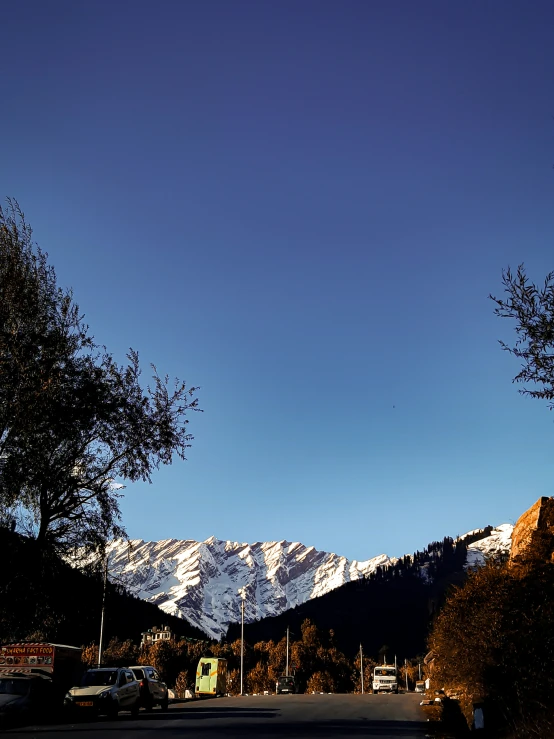 a view of mountains that have snow capped mountains in the distance