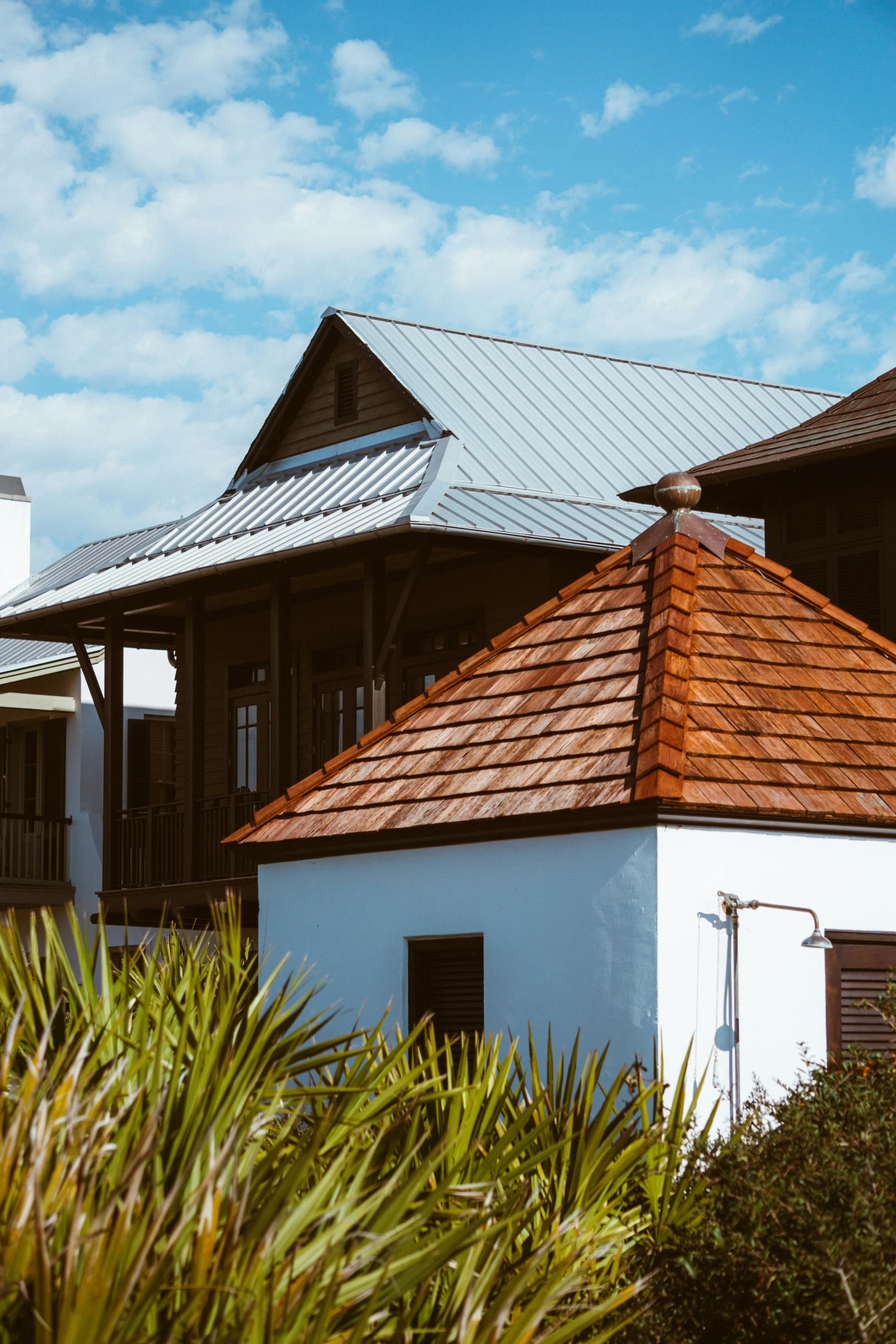 an old house with a tin roof and tile tiled roof