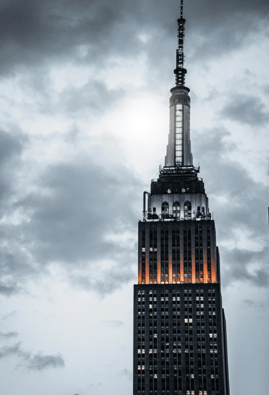 the top of a very tall building lit up at night