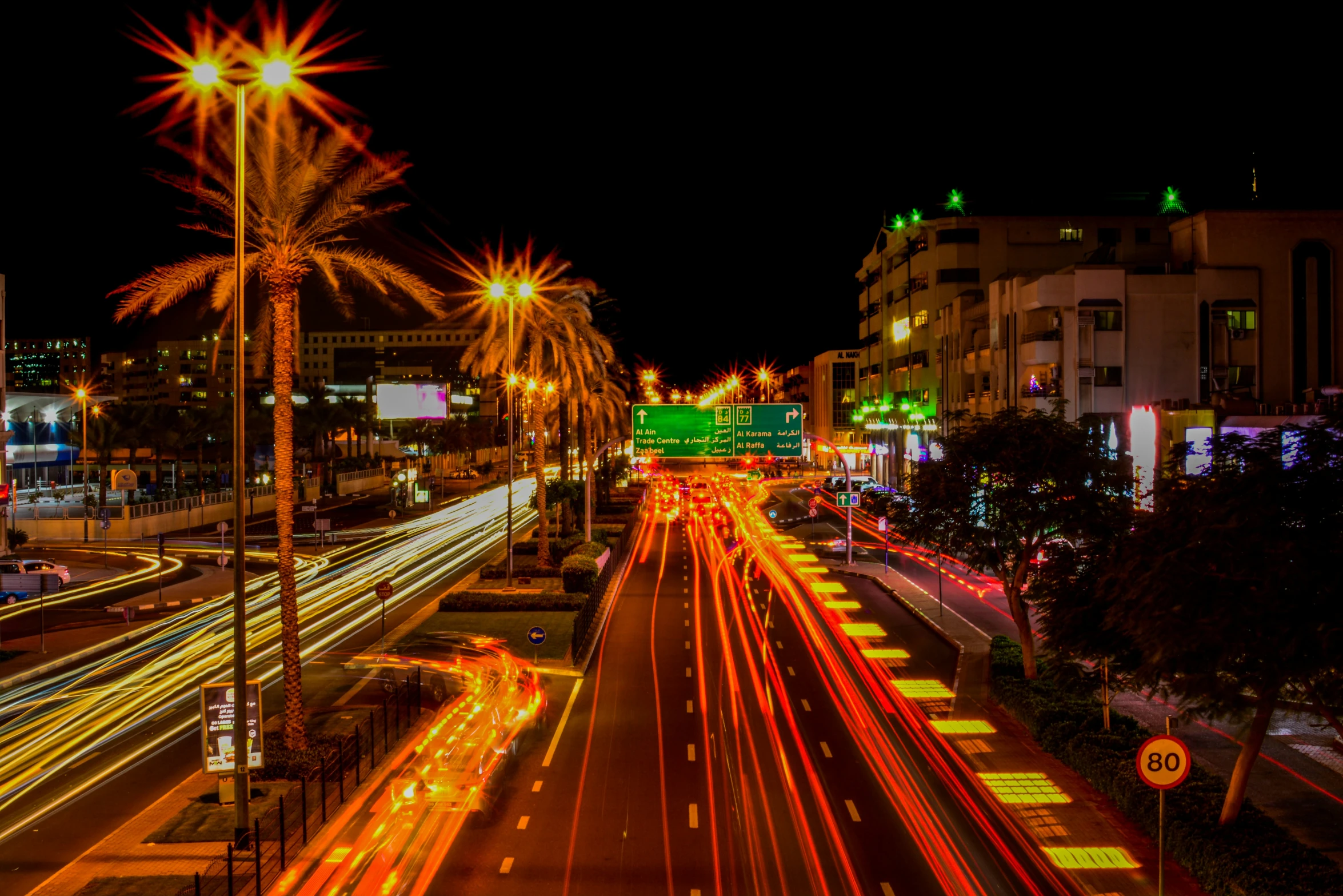 an image of city streets at night with a car driving